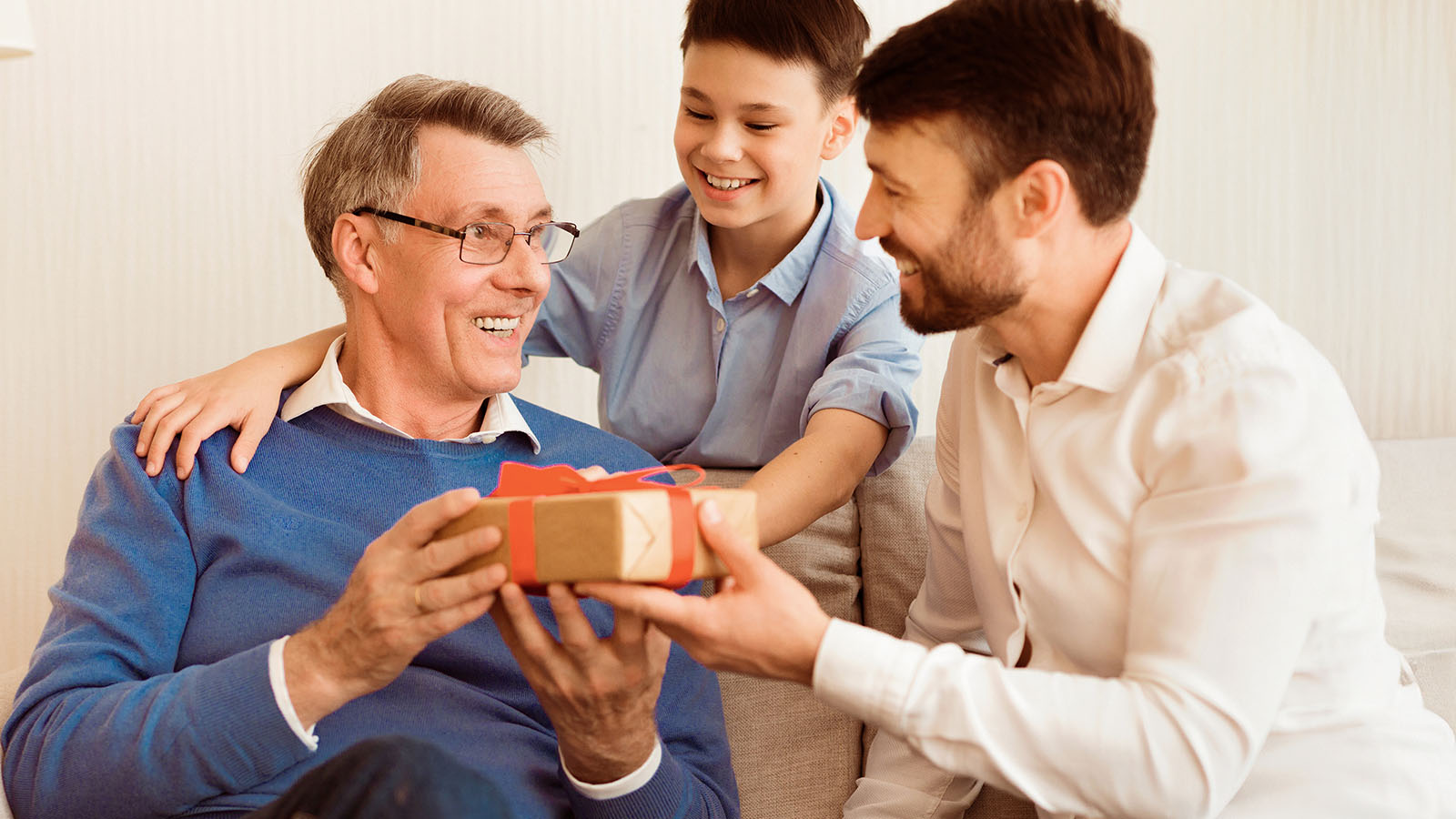 Dad and son giving gifts to grandpa
