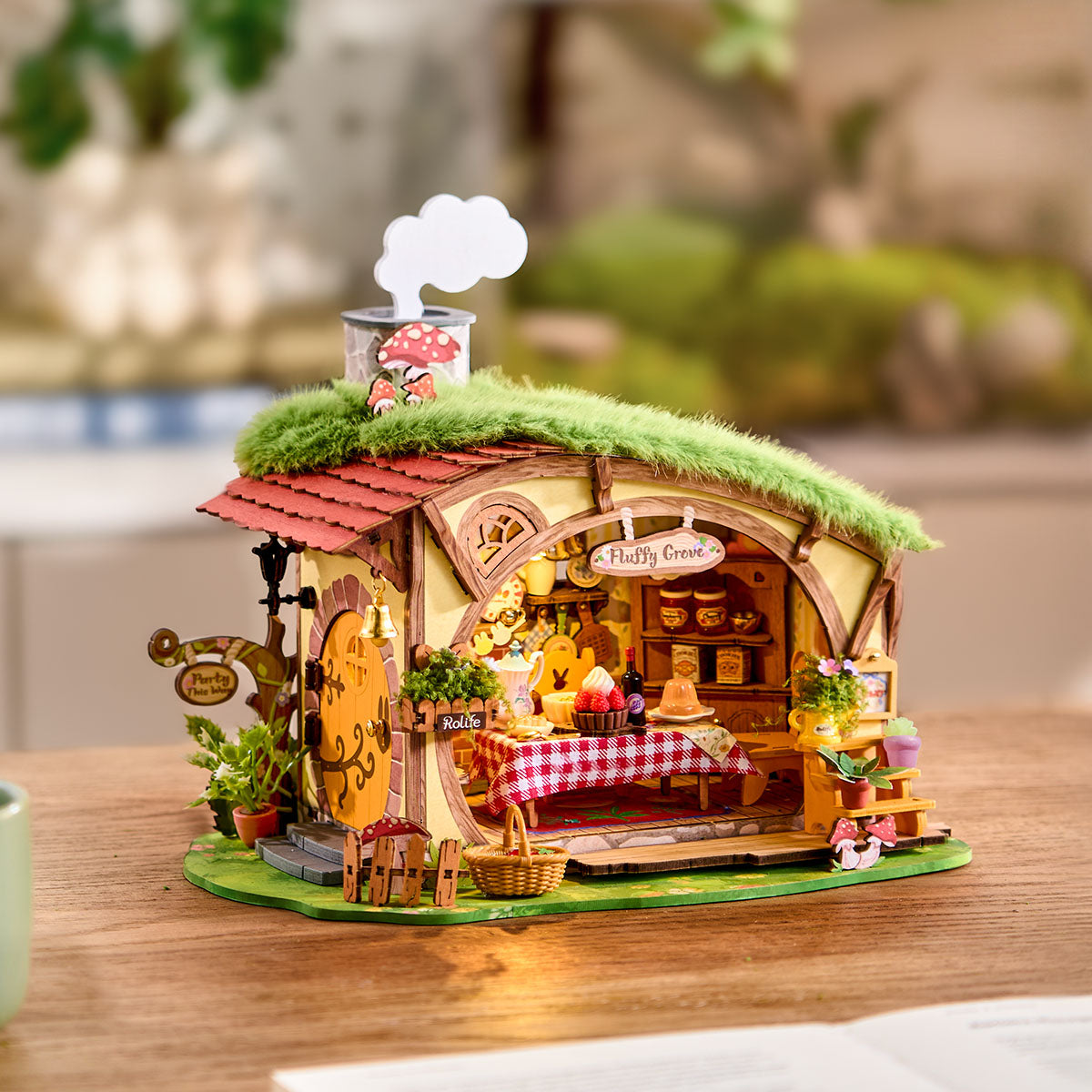 Rolife Fluffy Grove DIY Miniature House displayed on a tabletop with interior lights on
