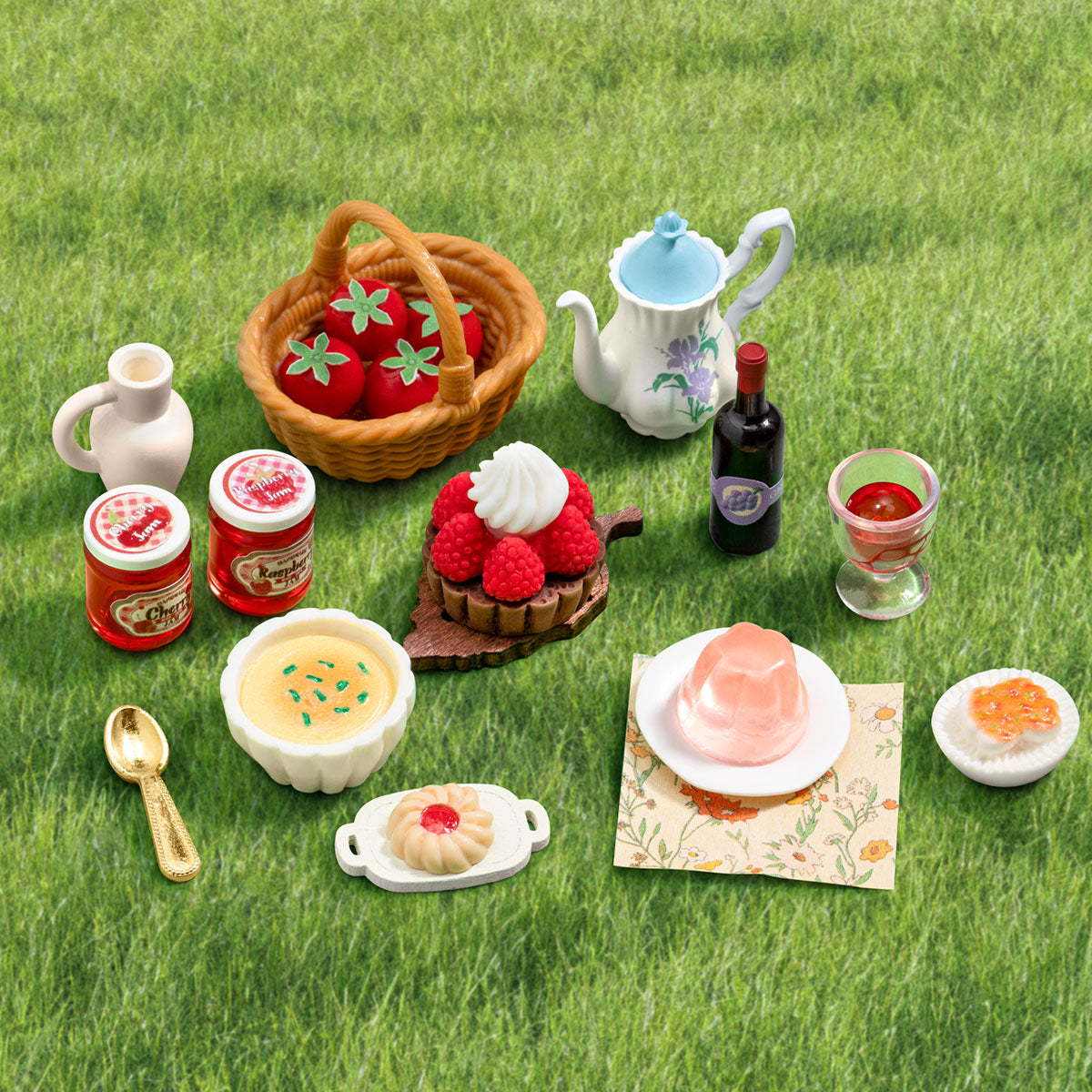 Close-up of Fluffy Grove miniature food accessories including jam jars, tea set, fruit basket, tart, and desserts
