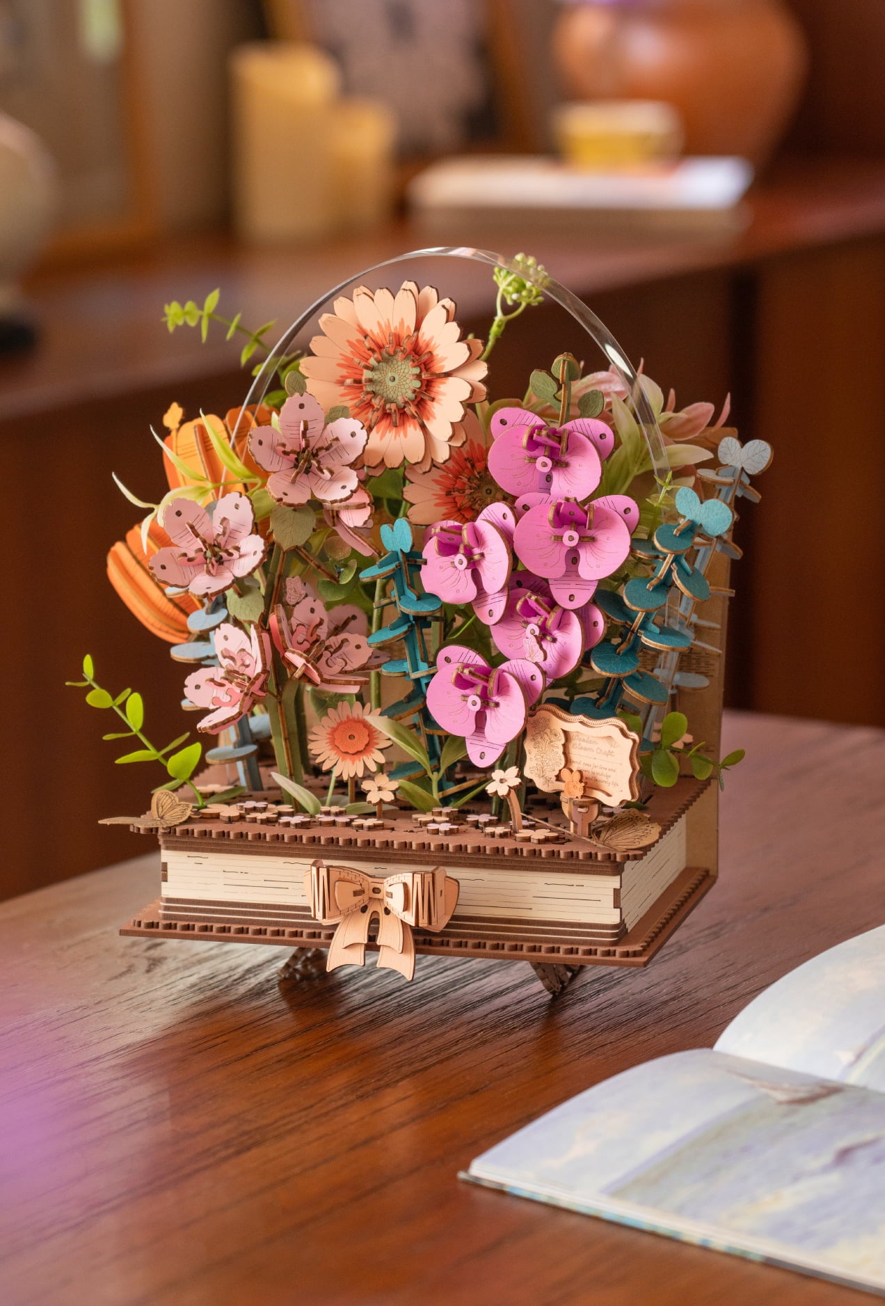 Wooden flower basket model filled with pink, orange and purple blossoms on a table