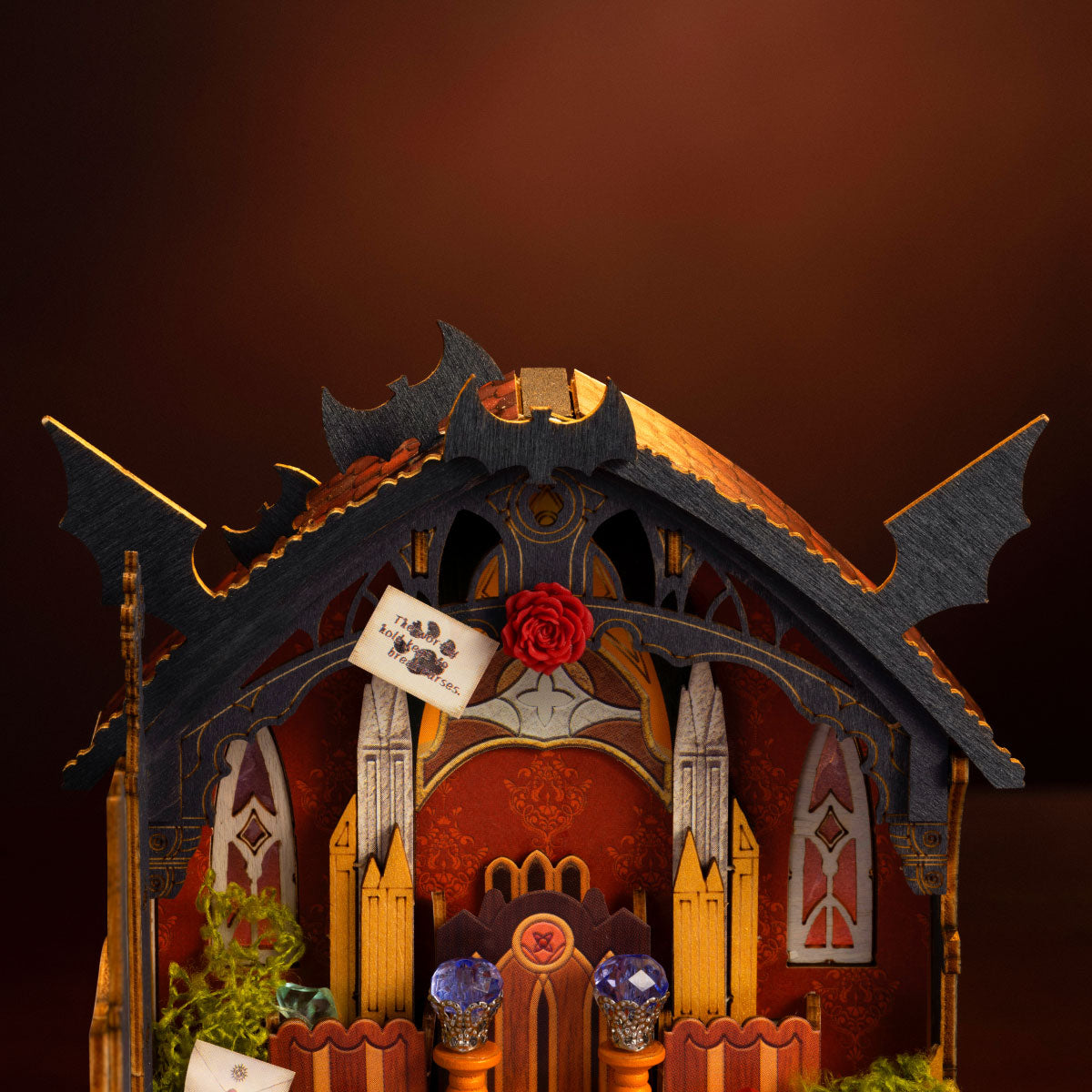 Rolife Rosa Salon DS055 close-up of gothic roof and wall details with rose decoration, bat wing accents, note sign and warm lighting