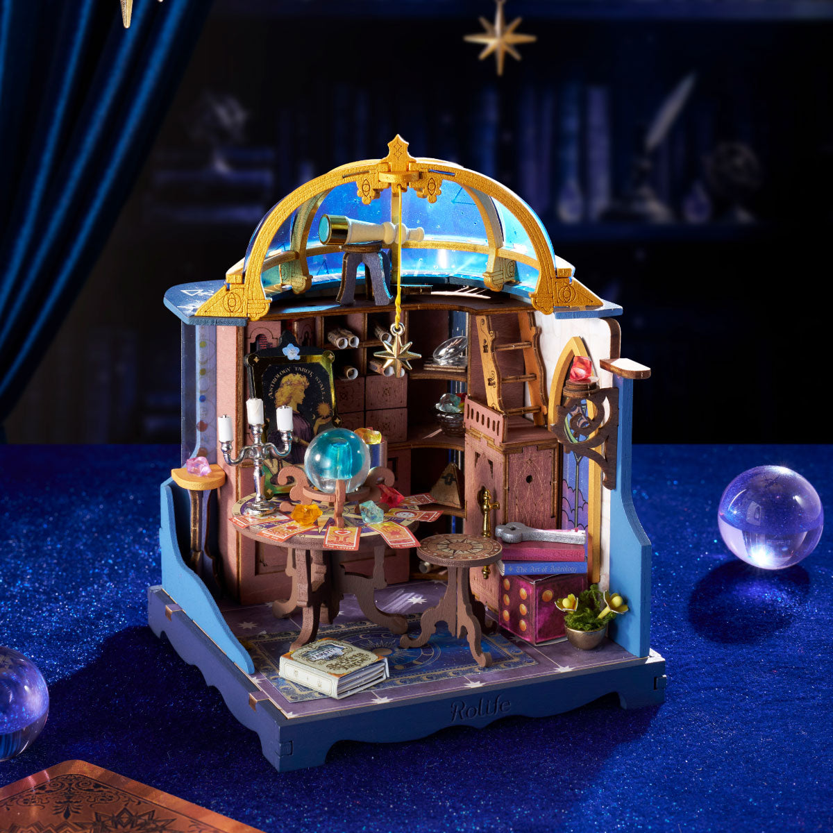 Rolife Astral Dome DS058 displayed on deep blue velvet with telescope, crystal ball, tarot table, hanging star and glowing night-sky dome