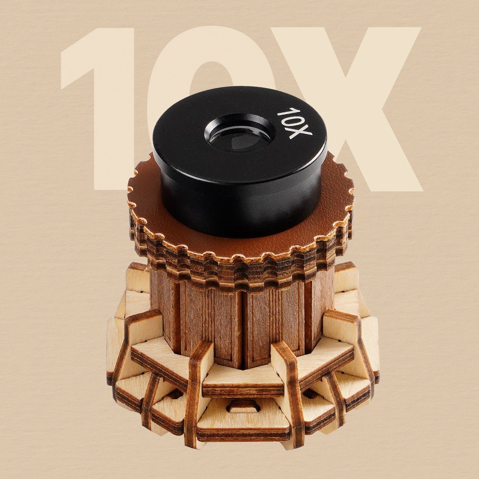 ROKR wooden microscope 10X objective lens shown close-up with a round black lens cap and golden wood gear base on tan background
