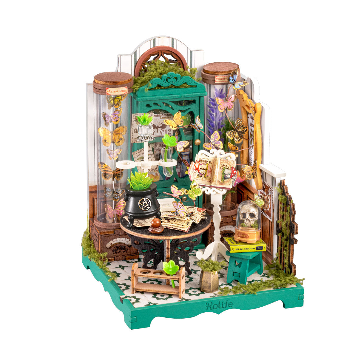 Rolife Potions Workshop DS057 white background product image showing a green butterfly apothecary miniature with potion jars, black cauldron, spell books, skull dome and moss