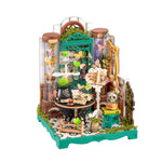 Rolife Potions Workshop DS057 white background product image showing a green butterfly apothecary miniature with potion jars, black cauldron, spell books, skull dome and moss