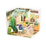 Rolife Blooming Tea Garden miniature room kit displayed with packaging and a pastel greenhouse scene