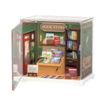 Rolife Memory Book Store DWS04B with dimensions shown: 5.79in wide by 4.29in deep by 6.18in tall, displaying the green bookshop interior inside its clear case.