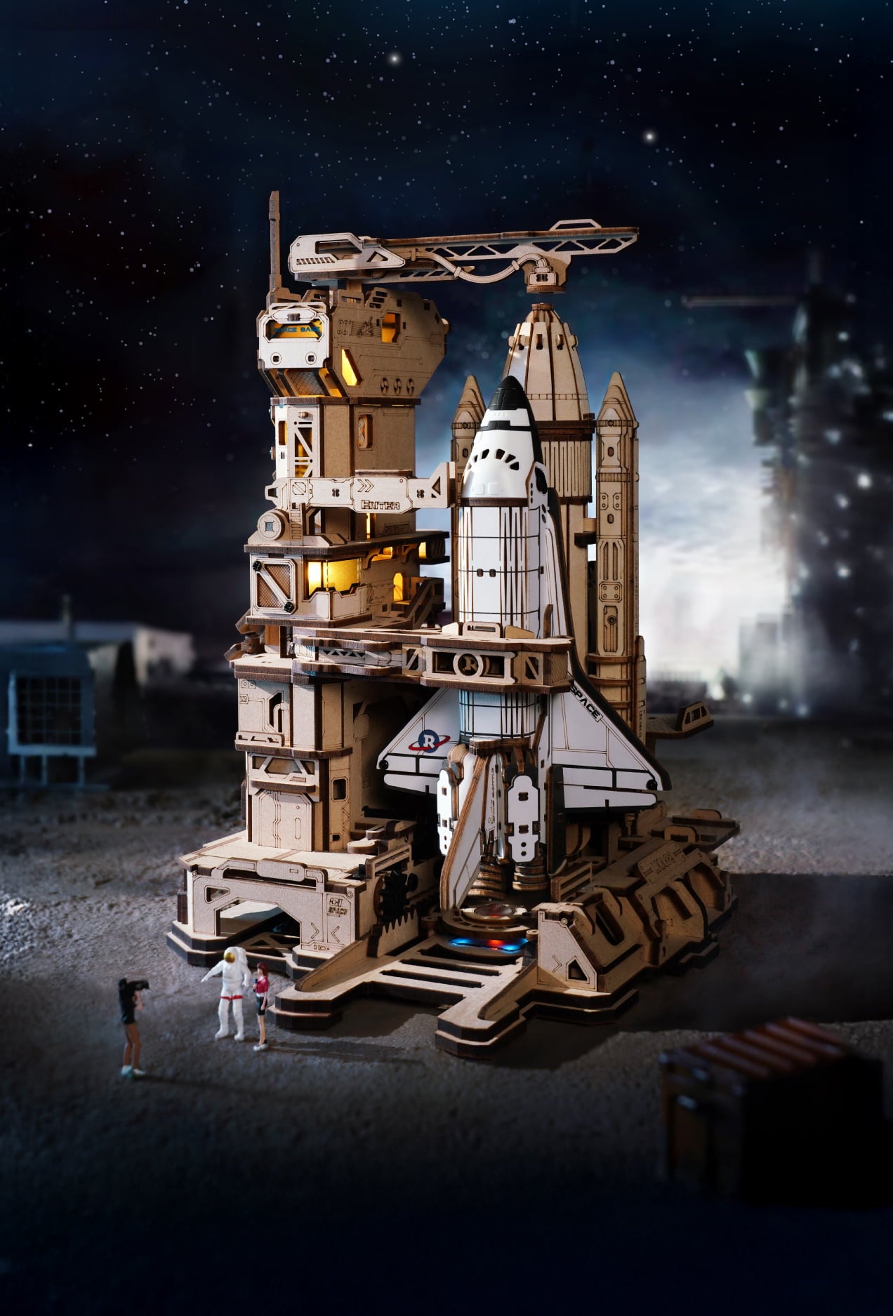 Wooden space shuttle launch model standing on a detailed platform against a starry sky