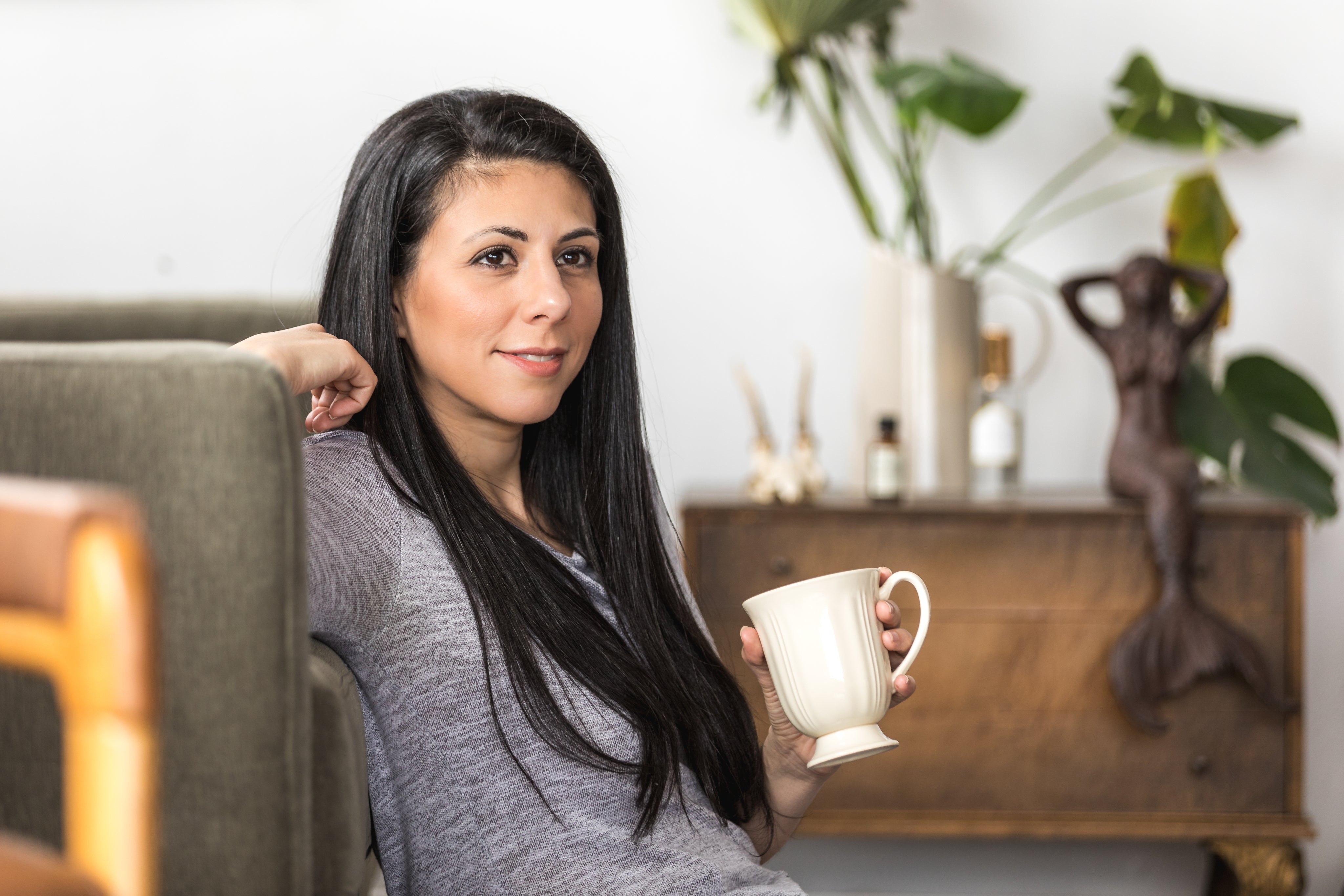 Robotime Online young woman leans back on couch with coffee